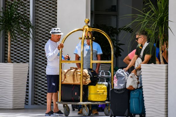 Guests with luggage outside a hotel